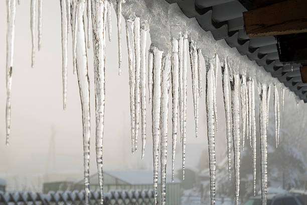 icicles on the eaves Winter thaw in Siberia. dam photos stock pictures, royalty-free photos & images