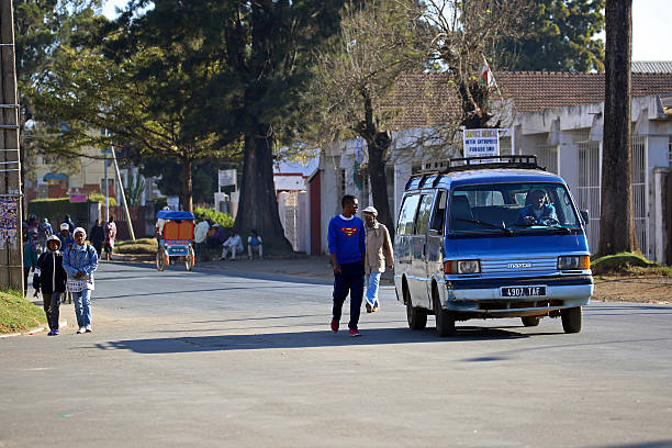 Miandrivazo, Madagascar - October 11 2025: An overloaded minivan (taxi-brousse) transporting goods and passengers through the bustling town of Miandrivazo.