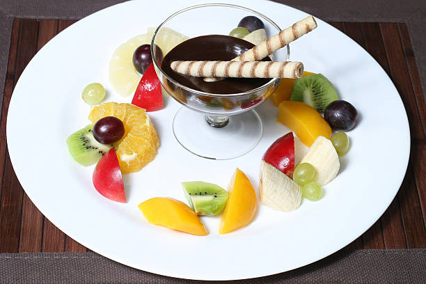 fruit apples, kiwi, bananas, pineapples, grapes with syrup