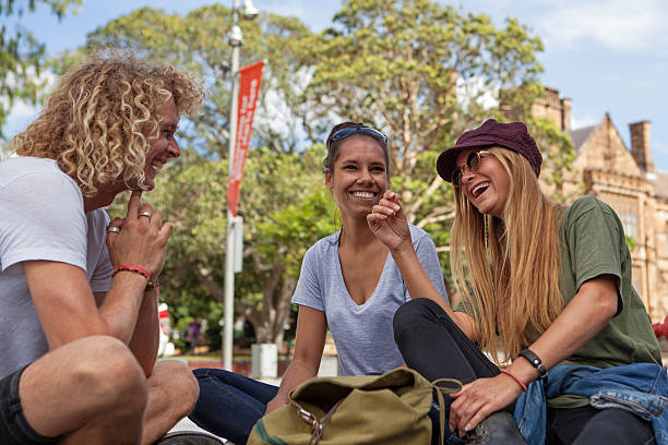 students laughing and having fun Urban students having a conversation outside the university. university students australia stock pictures, royalty-free photos & images