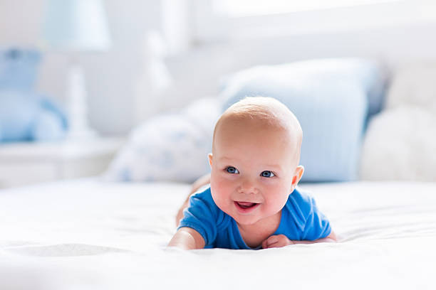 istock Baby boy in white sunny bedroom 499149430