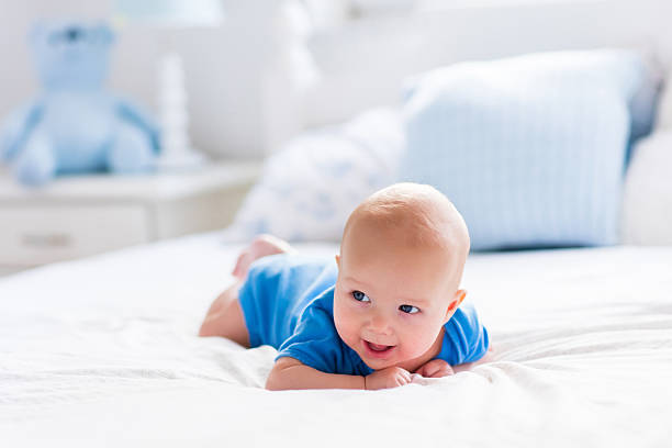 istock Baby boy in white sunny bedroom 499150990