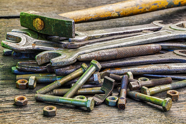 istock Old,rusted wrenches bolts,nuts and hammer on table 499151236