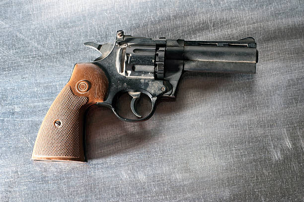 istock revolver on metal background 499152116