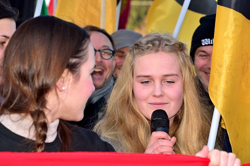 Spielfeld, Austria - November 28, 2015: Beautiful girl speaking at international blockade by 1000 activists of the Austrian identitarian movement of the border crossing near Spielfeld.