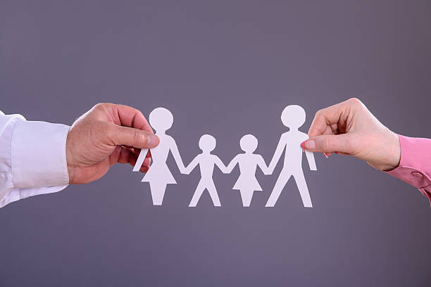 istock hands holding a paper family 499153036