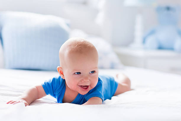 istock Baby boy in white sunny bedroom 499155592