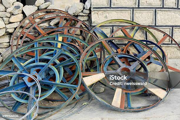Iron Wheels Leaning On The Wall Sakyatibet 1891 Stock Photo - Download Image Now - 2015, Brick, Brick Wall