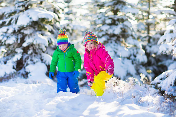 istock Children playing in snowy winter park 499156318