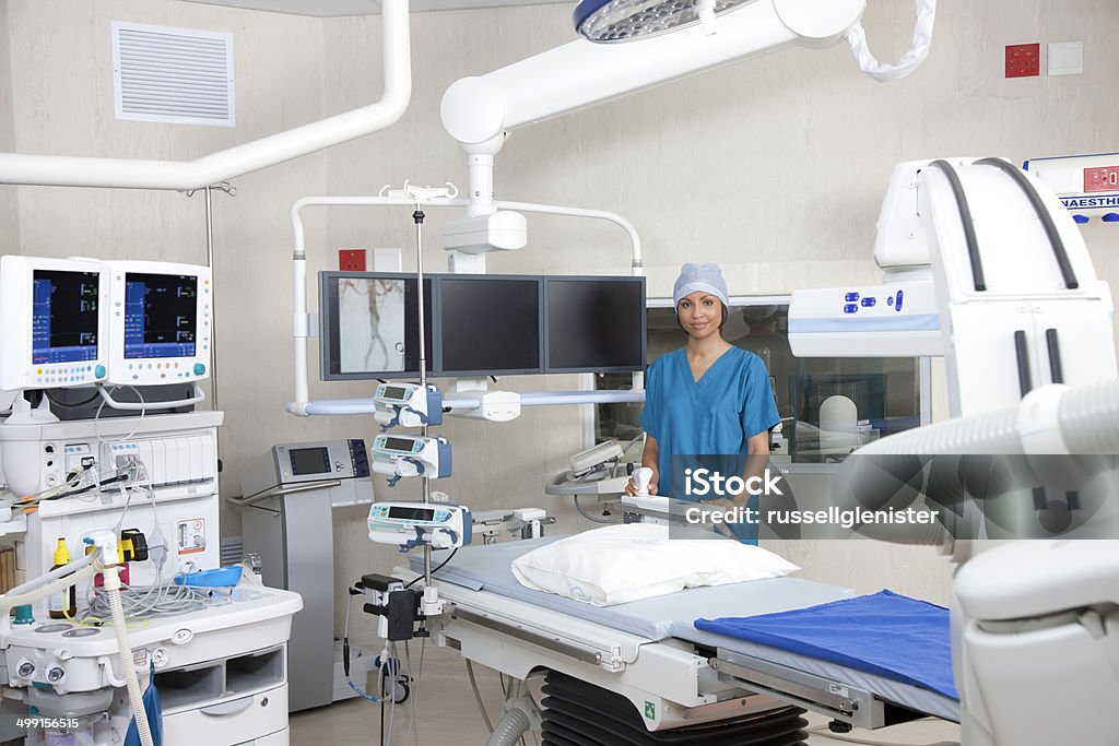 Nurse in operating theatre with robotic imaging system  CAT Scan Stock Photo