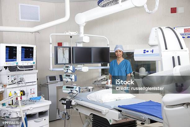 Nurse In Operating Theatre With Robotic Imaging System Stock Photo - Download Image Now
