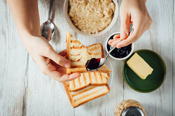 istock Man hands eating toast for breakfast 499156818