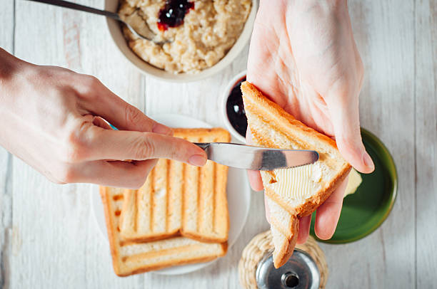 istock Man hands eating toast for breakfast 499157038
