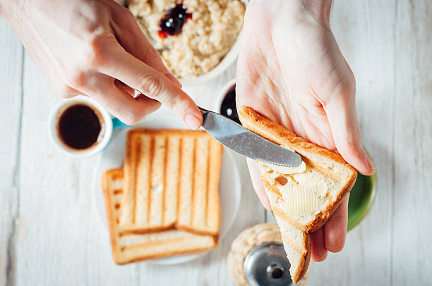 istock Man hands eating toast for breakfast 499157076
