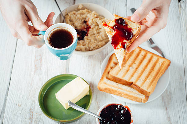 istock Man hands eating toast for breakfast 499157368