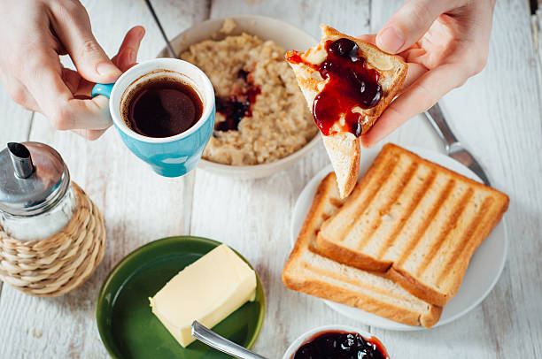 istock Man hands eating toast for breakfast 499157420