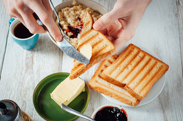 istock Man hands eating toast for breakfast 499157504