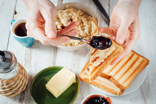 istock Man hands eating toast for breakfast 499157602