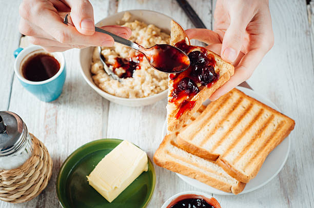 istock Man hands eating toast for breakfast 499157624