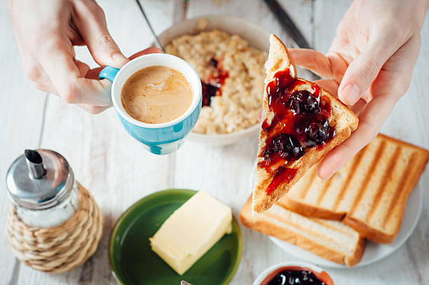 istock Man hands eating toast for breakfast 499157726