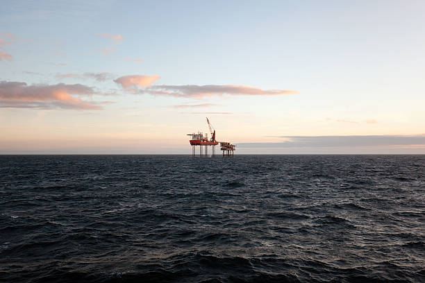 istock Horizon over water with oil platform in center 499158396