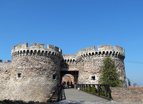 Belgrade, Serbia - August 30, 2015: Tourists visit the old castle in Belgrade. They are entering from Front gate of Belgrad Fortresss. Zindan Gate is the middle southeastern gateof Belgrad Fortresss, between two round towers.