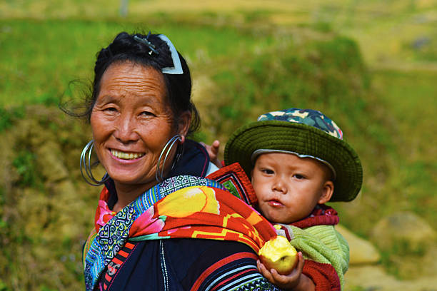 Sapa, Vietnam-November 21, 2015: It's an ordinary day in the H'mong tribe daily life, where the woman used to go around the villages or to the markets with their children held on their back.