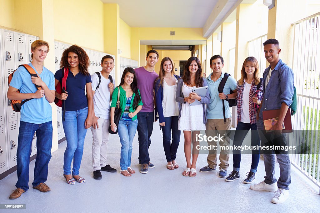Group Of High School Students Standing In Corridor Group Of High School Students Standing In Corridor Smiling To Camera High School Student Stock Photo