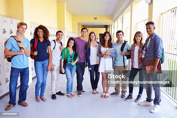 Group Of High School Students Standing In Corridor Stock Photo - Download Image Now - High School Student, Multiracial Group, Classroom