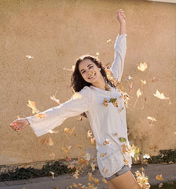 istock Young Adult Throwing Leaves 499170086