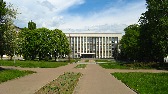 Chernihiv, Ukraine - May 9, 2011: Paths in park with a view on establishment in Chernihiv town, Ukraine