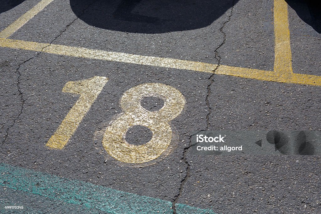 Number Eighteen Parking Slot Number Eighteen Parking Slot on the pavement Concrete Stock Photo