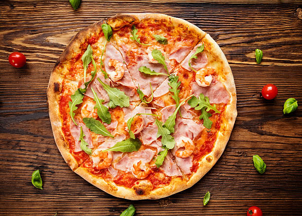 istock Delicious italian pizza served on wooden table 499171380