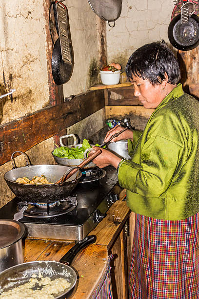 bhutanese woman in  the kitchen stock photo