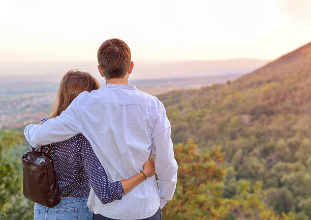 Romantic couple with the look at the sunset