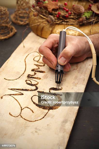 Merry Christmas Burning Subtitles In Wood Stock Photo - Download Image Now  - Pyrography, Christmas, 2015 - iStock