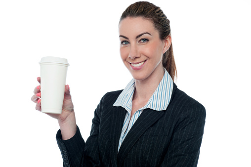 Woman in business suit holding beverage