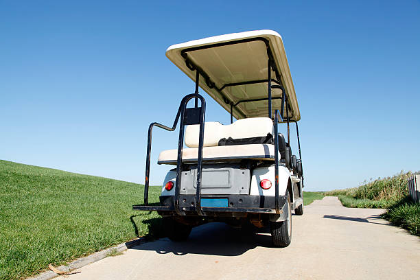 istock White golf carts at the green golf course 499175686