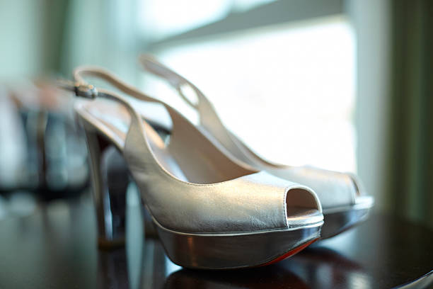 istock Silver sandals with heel, adjustable strip and red sole 499175918