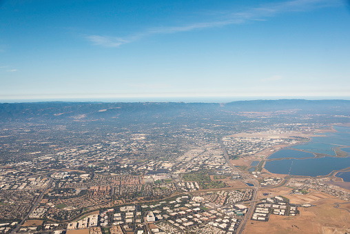 An Aerial view of the cities San Jose, Mountain View, Santa Clara,, Cupertino, and Palo Alto at the southern end of San Francisco Bay. The Alviso district of San Jose can be seen in the far right corner. Moffet Field Naval Air Station can be seen in the center left of the picture. On the other side of the peninsula is the Pacific Ocean. Levi Stadium can be seen in the center right area of the picture (home of the San Francisco 49ers)