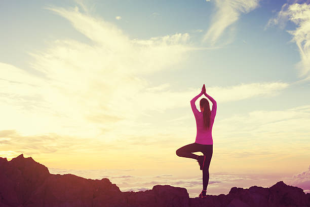 istock Woman Practicing Yoga in the Mountains at Sunset 499179164