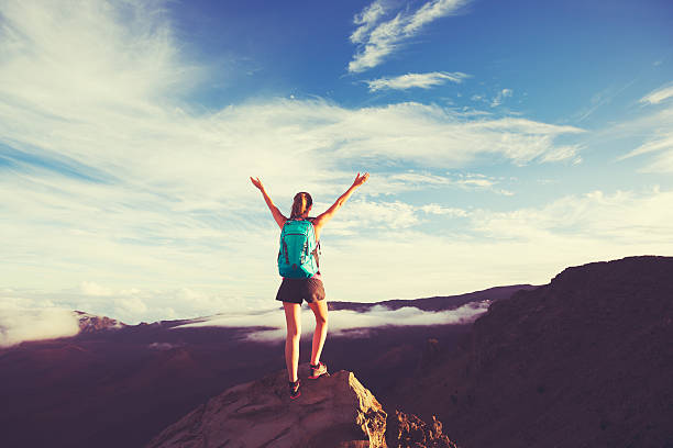 istock Young Woman with Backpack on Mountain Peak with Open Arms 499179448