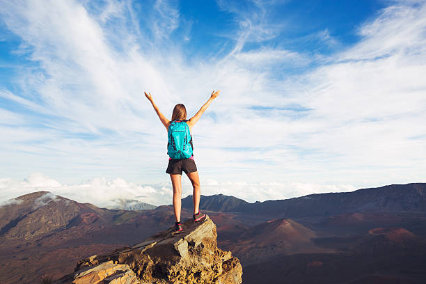istock Young Woman with Backpack on Mountain Peak with Open Arms 499179520