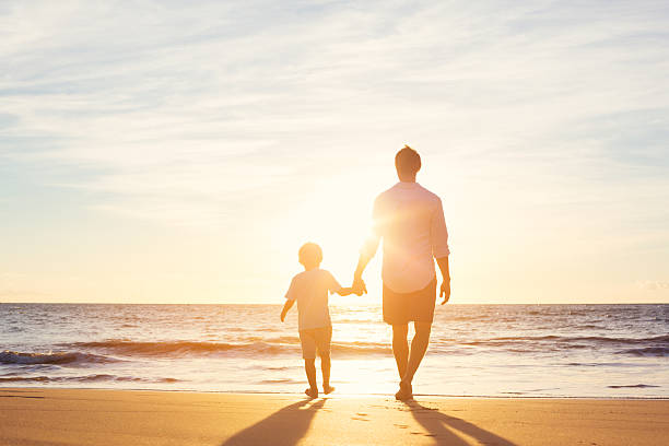 istock Father and Son Walking Together on the Beach 499180264