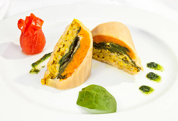 Potato roulade with spinach, carrot and curry rice stock photo