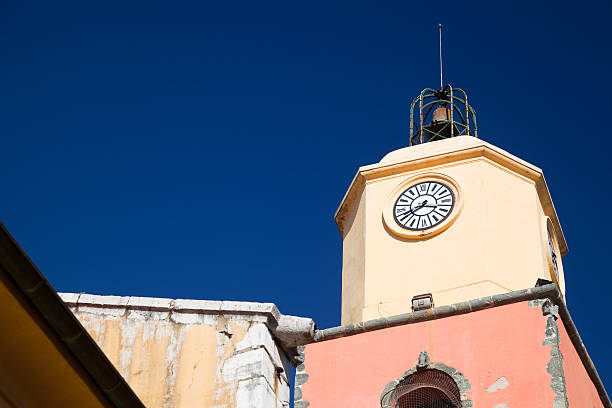Old pastel or Mediterranean colored (with ochre and Sienna earth) church tower Saint-Tropez, France, the 18th-century Eglise de Notre-Dame de l'Assomption (Our Lady of the Assumption)