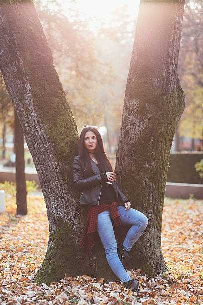 istock Beautiful young woman posing in park 499182510