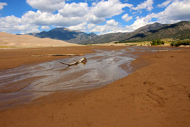 istock Dried up Creek overlooking The Great Sand Dunes and Mountains 499183834