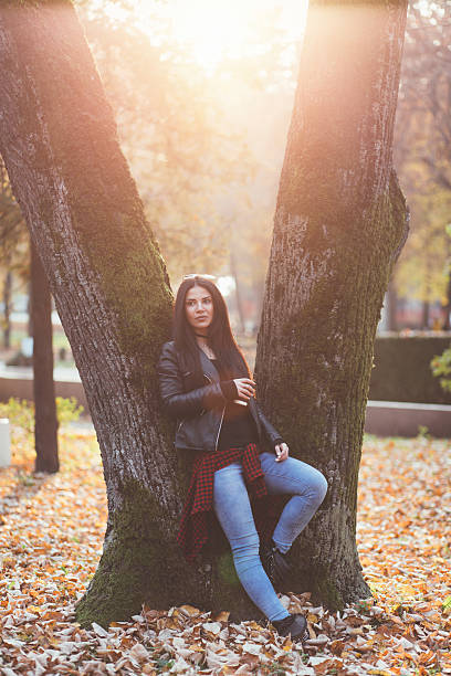 istock Beautiful young woman posing in park 499183882
