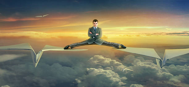 istock Businessman flying on paper planes 499191307